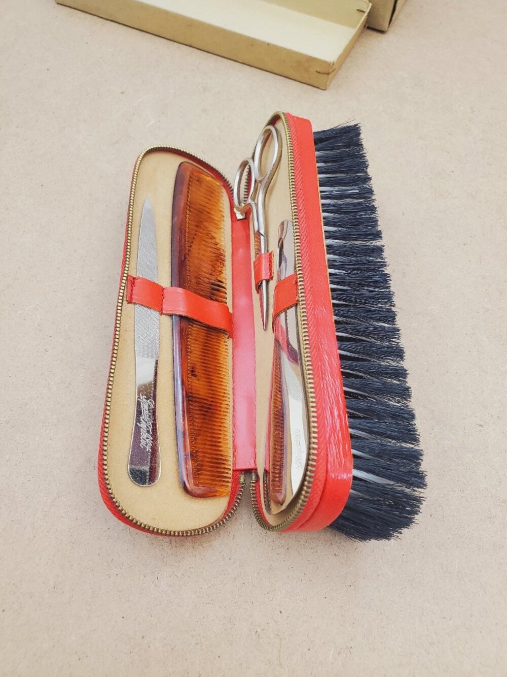 Vintage Gentlemens travel clothes brush and manicure set in a zipped case.